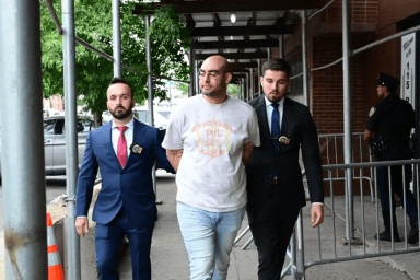 Corona resident Ali Hames was escorted out of the 115th Precinct in Jackson Heights after he was arrested for allegedly offering a 14-year-old girl cash for sex in late June.