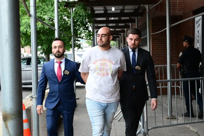 Corona resident Ali Hames was escorted out of the 115th Precinct in Jackson Heights after he was arrested for allegedly offering a 14-year-old girl cash for sex in late June.