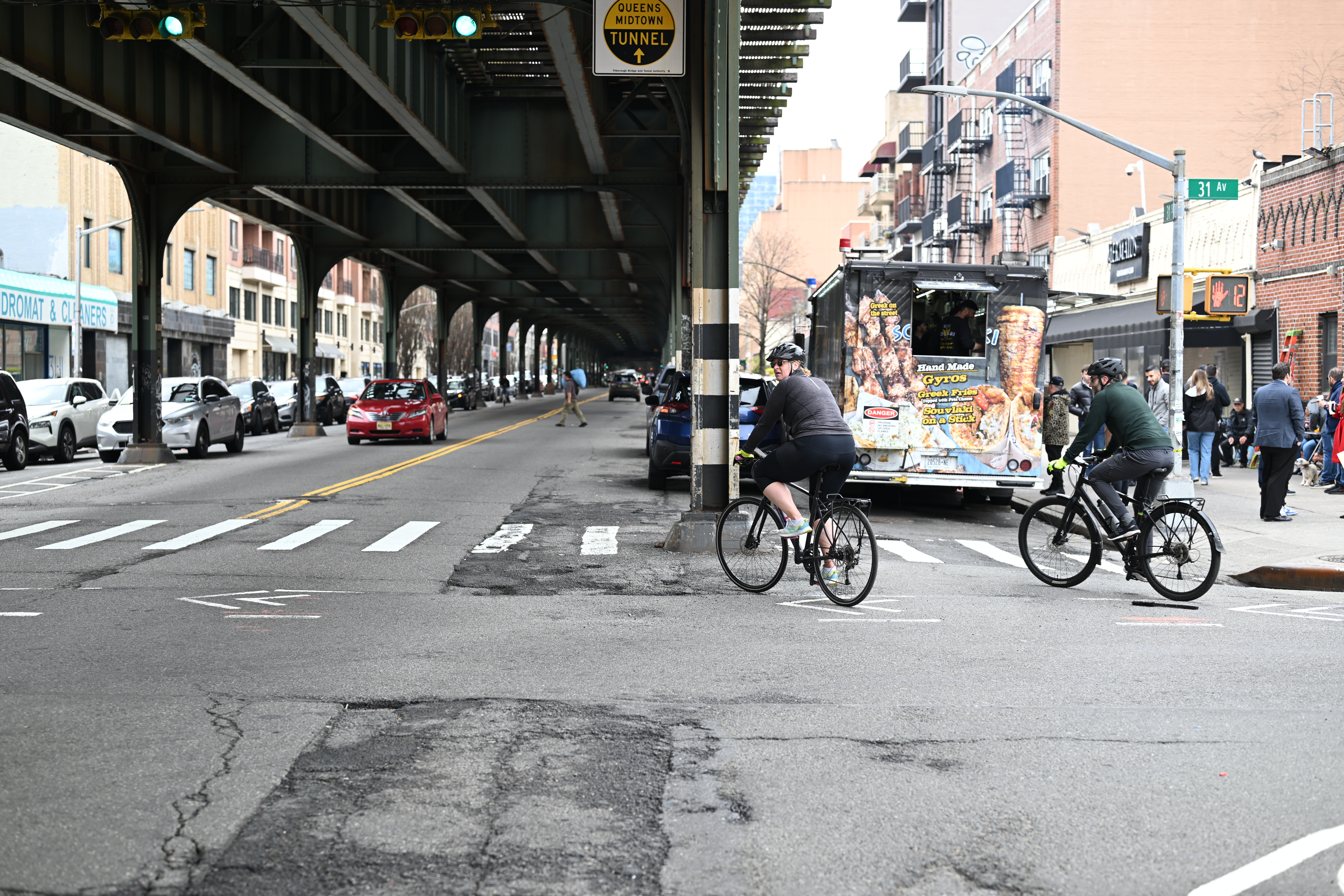 Cyclists along 31st Street in Astoria. The DOT has proposed installing protected bike lanes on each side of the corridor.