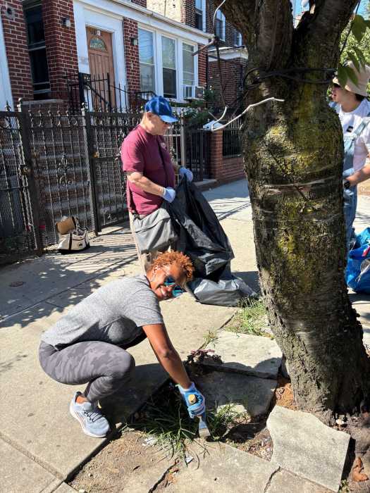 Shanel Thomas-Henry, the Democratic Nominee for Council District 21, takes part in Street Tree Care Day. Photo: Corona Mutual Aid. 