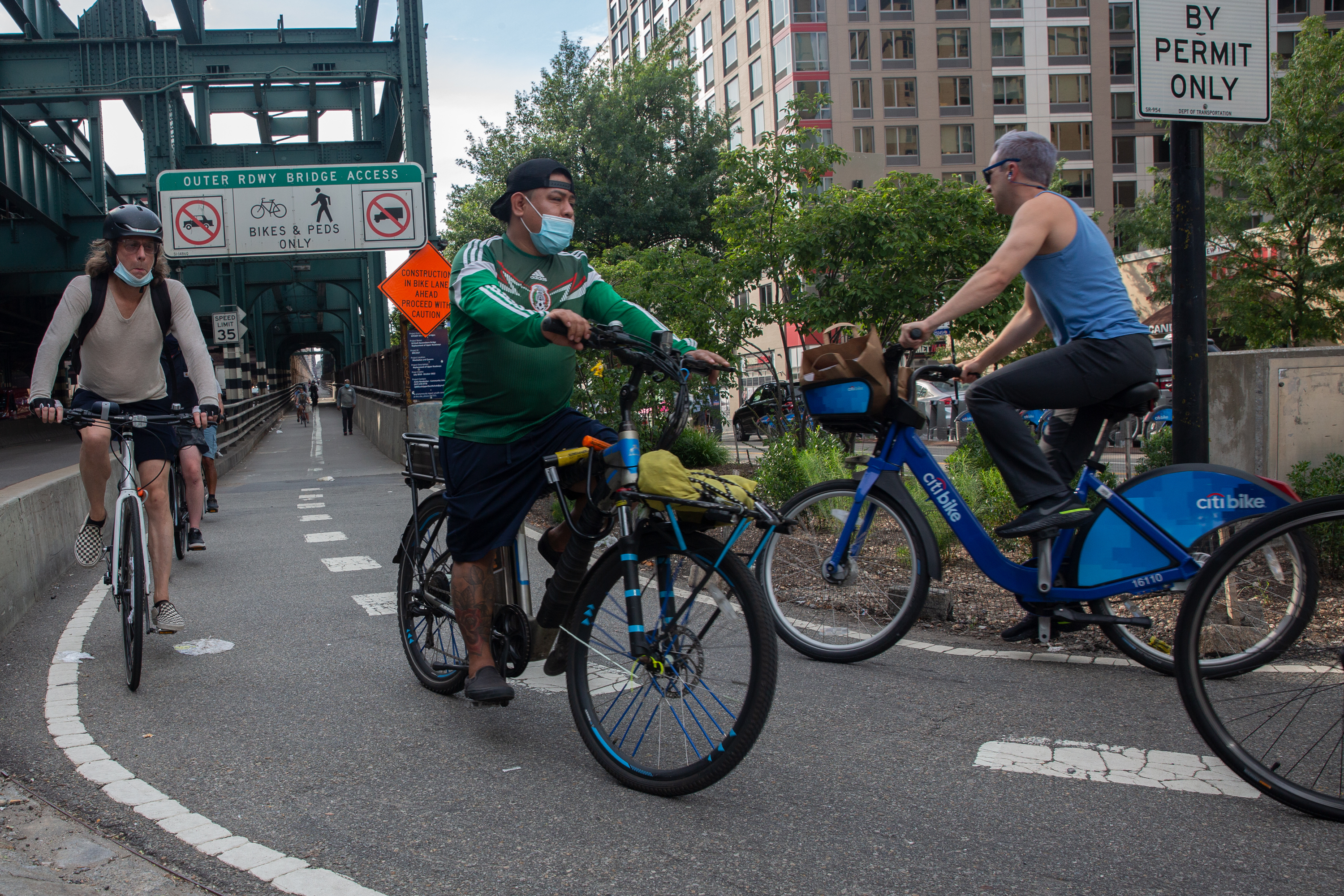 Cyclists ride over the Queensboro Bridge, Aug. 3, 2020.