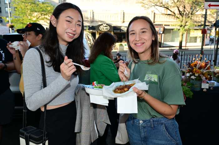 Attendees enjoy taco bowls at the Sunnyside Night Market. Photo: Ramy Mahmoud.