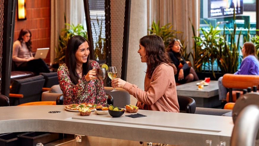 Customers eating and drinking at the bar (Photo provided by The Bar at JACX&CO)