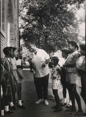 Armstrong with neighborhood children. Photo Chris Barham/Louis Armstrong House Museum.