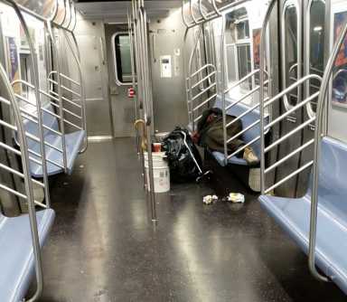 NYC_homeless_person_on_E_train