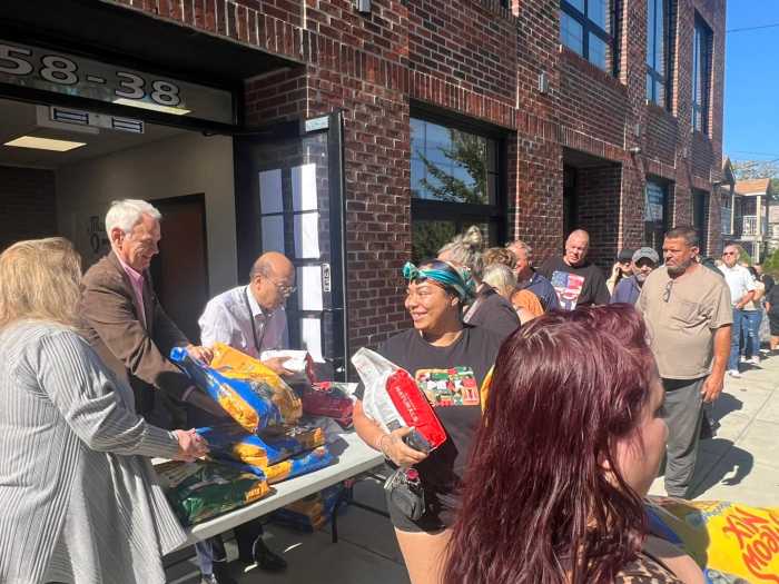 Holden distributed free bags of cat and dog food at the event on Saturday. Photo via Council Member Robert Holden Facebook.