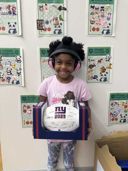 Third grader Ava Marie with a special-edition Giants football. Photo courtesy of Nicolas Cocchiario.