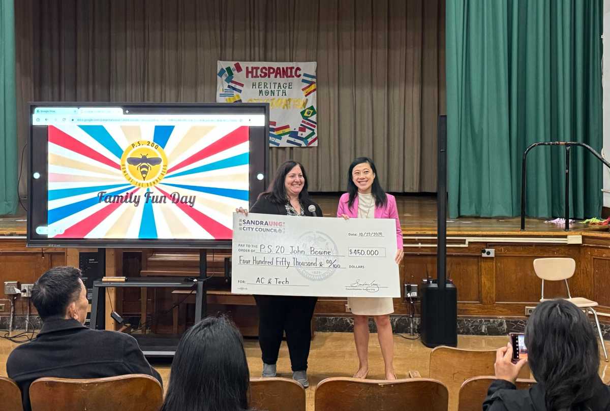 Council Member Sandra Ung (r.), presented a $450,000 check to PS 20 Principal Elisa Barresi, which will be used to fund a cooling project and technology upgrades, during Family Day on Oct. 22.