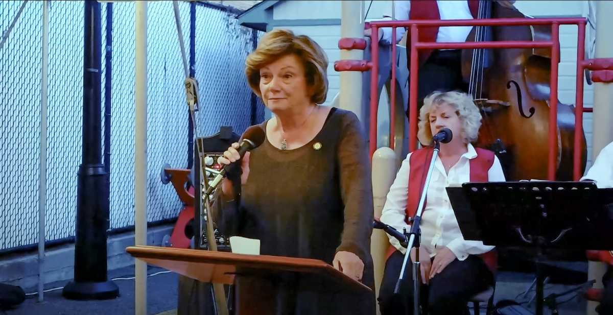 Marge Markey speaking at the Maspeth Town Hall 110th Anniversary celebration in 2014.