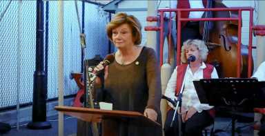 Marge Markey speaking at the Maspeth Town Hall 110th Anniversary celebration in 2014.