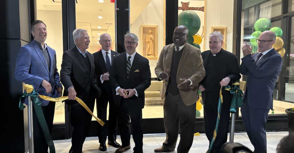 Holy Cross High School President Mark Mongelluzzo (third from r.) cuts the ribbon to the brand new Arts, Technology and Athletics Center building alongside school staff and religious officials during a dedication ceremony on Oct. 23.