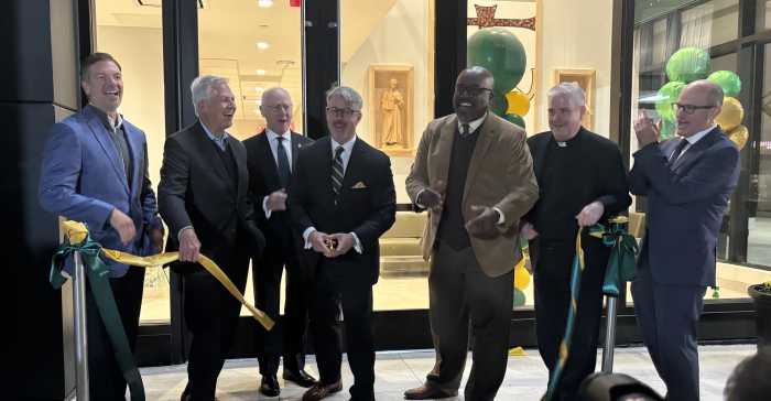 Holy Cross High School President Mark Mongelluzzo (third from r.) cuts the ribbon to the brand new Arts, Technology and Athletics Center building alongside school staff and religious officials during a dedication ceremony on Oct. 23.