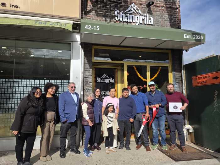Elected officials, community members and Café Shangrila owners at the ribbon-cutting for Sunnyside's new Himalayan restaurant. Photo: Shane O'Brien