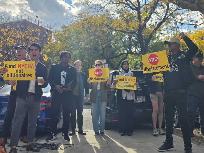 Protesters held signs calling for development in NYCHA. Photo: Shane O'Brien.