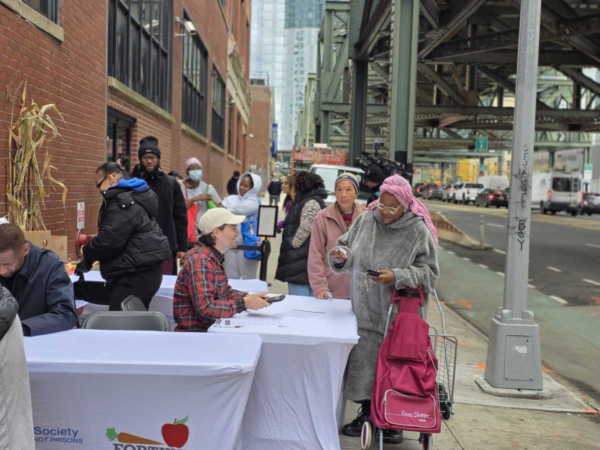 Individuals sign up to the Fortune Society's new weekly food distribution program in Long Island City. Photo by Shane O'Brien.