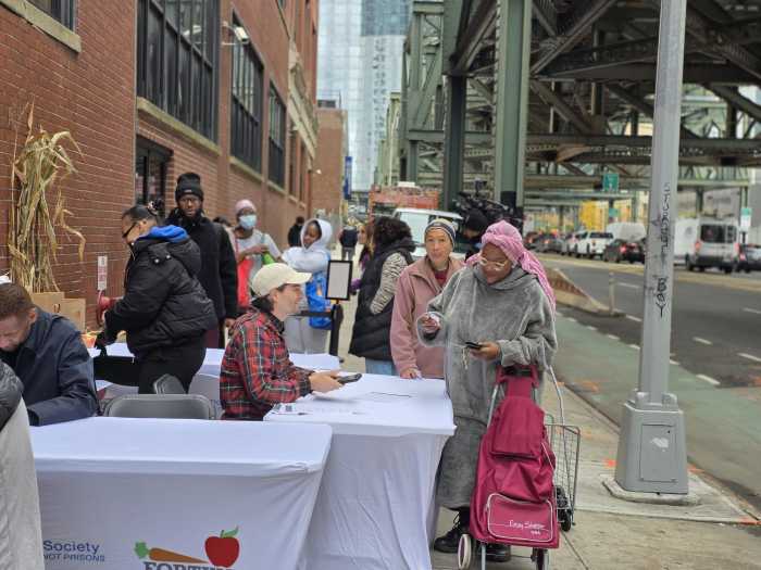 Individuals sign up to the Fortune Society's new weekly food distribution program in Long Island City. Photo by Shane O'Brien.