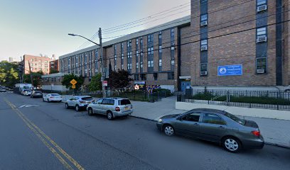 A former staffer at the East-West School of International Studies in Flushing has been charged with stealing more than $400,000 in taxpayer funds meant for students.