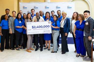 U.S. Rep. Alexandria Ocasio-Cortez presented NHS Queens with a check for $2.4 million. Photo via office of Alexandria Ocasio-Cortez.