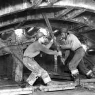 Workers tighten Queens-Midtown Tunnel bolt with 5' ratchet wrench in north tunnel, Queens. February 26, 1939. Photo by Somach Photo Service.