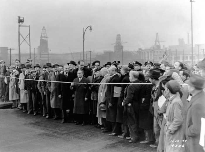 Gladys Harvey, wife of Queens Borough President George U. Harvey, prepares to cut the tape opening the Midtown Highway. November 15, 1940. Photographer unknown.