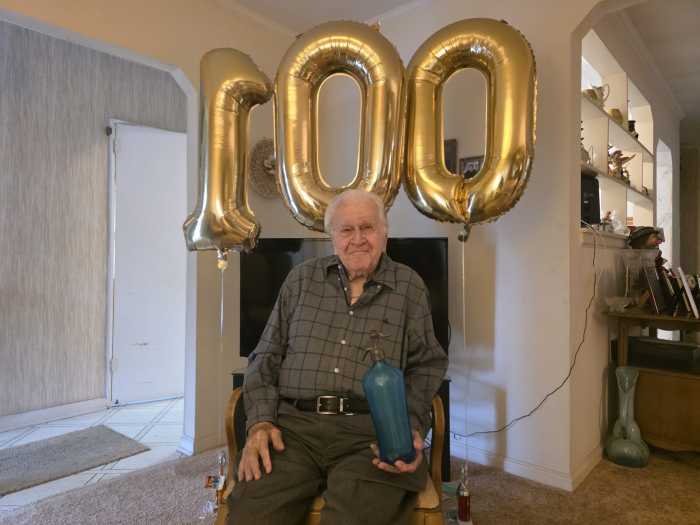 Sidney Weber holds a traditional seltzer bottle at his home in Fresh Meadows. Photo by Shane O'Brien.