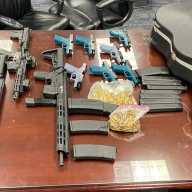 Ghost guns, assault rifles, high-capacity magazines, ammunition and a guitar case where guns were hidden were recovered from an Elmhurst garage defendants used to store weapons.