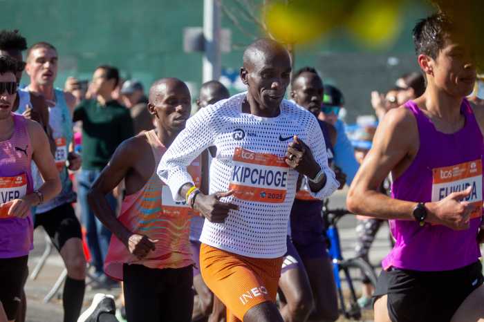 Eliud Kipchoge leading the professional men's field at his final professional marathon in Long Island City.