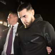 Justin Aguilera is led out of the 109 Precinct on Dec. 4, 2025, following his arrest on gang assault, assault, riot and trespassing charges.