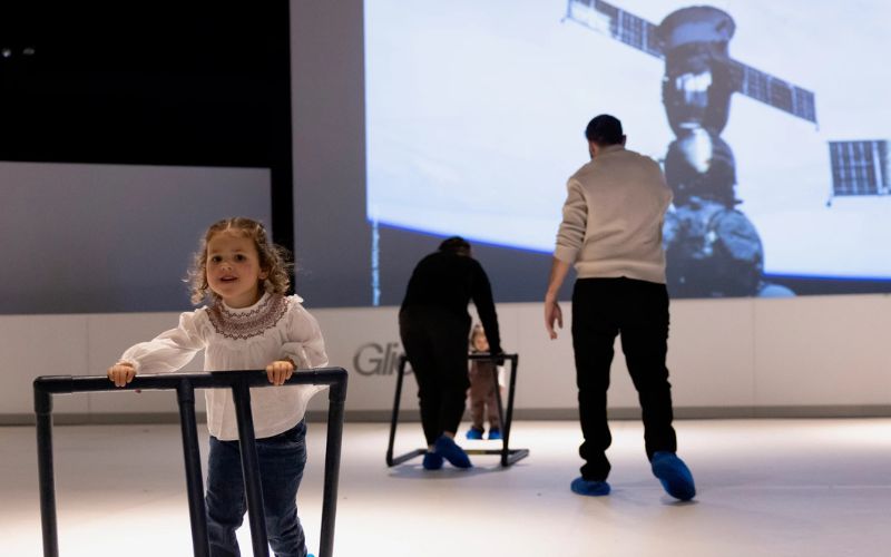Guests glide through NYSCI's "Space Glide" rink. Photo via the New York Hall of Science.