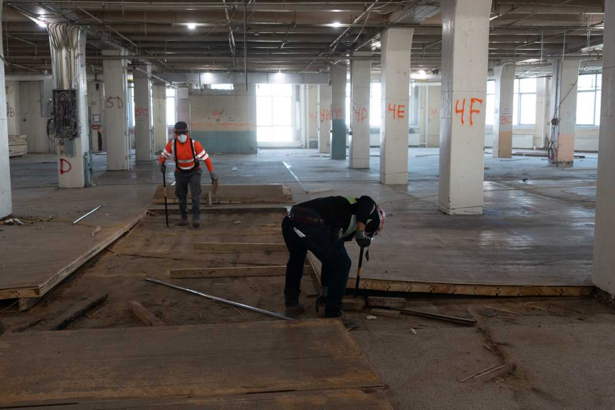 Workers rip up 100-year-old hardwood floors at LaGuardia College's Building C. Photo Courtesy of LaGuardia Community College.