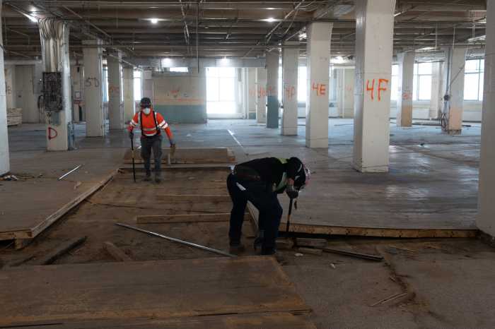 Workers rip up 100-year-old hardwood floors at LaGuardia College's Building C. Photo Courtesy of LaGuardia Community College.