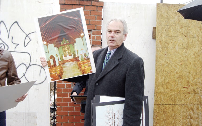 Robert Holden holds up historic photo of St. Saviour's Church