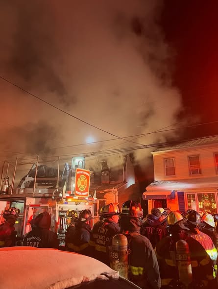 Firefighters battled a two-alarm fire at 70-07 57th Road after the blaze spread to a neighboring home. 