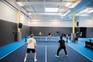 Players take to the court at Gotham Pickleball's original LIC location. Photo via David Goldberg.