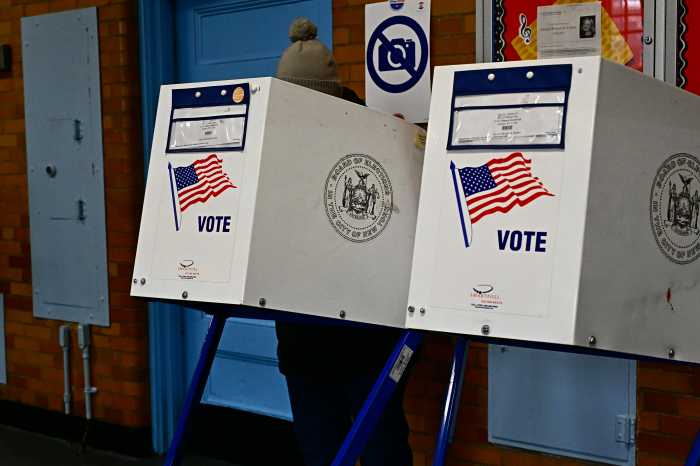 A resident casts their vote at P.S. 122Q. Photo by Ramy Mahmoud.