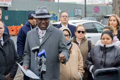 Attorney Ben Crump, the Injury Group and former residents of 1905 Flushing Ave. gather across the street from the site of the fire to call for a full investigation.
