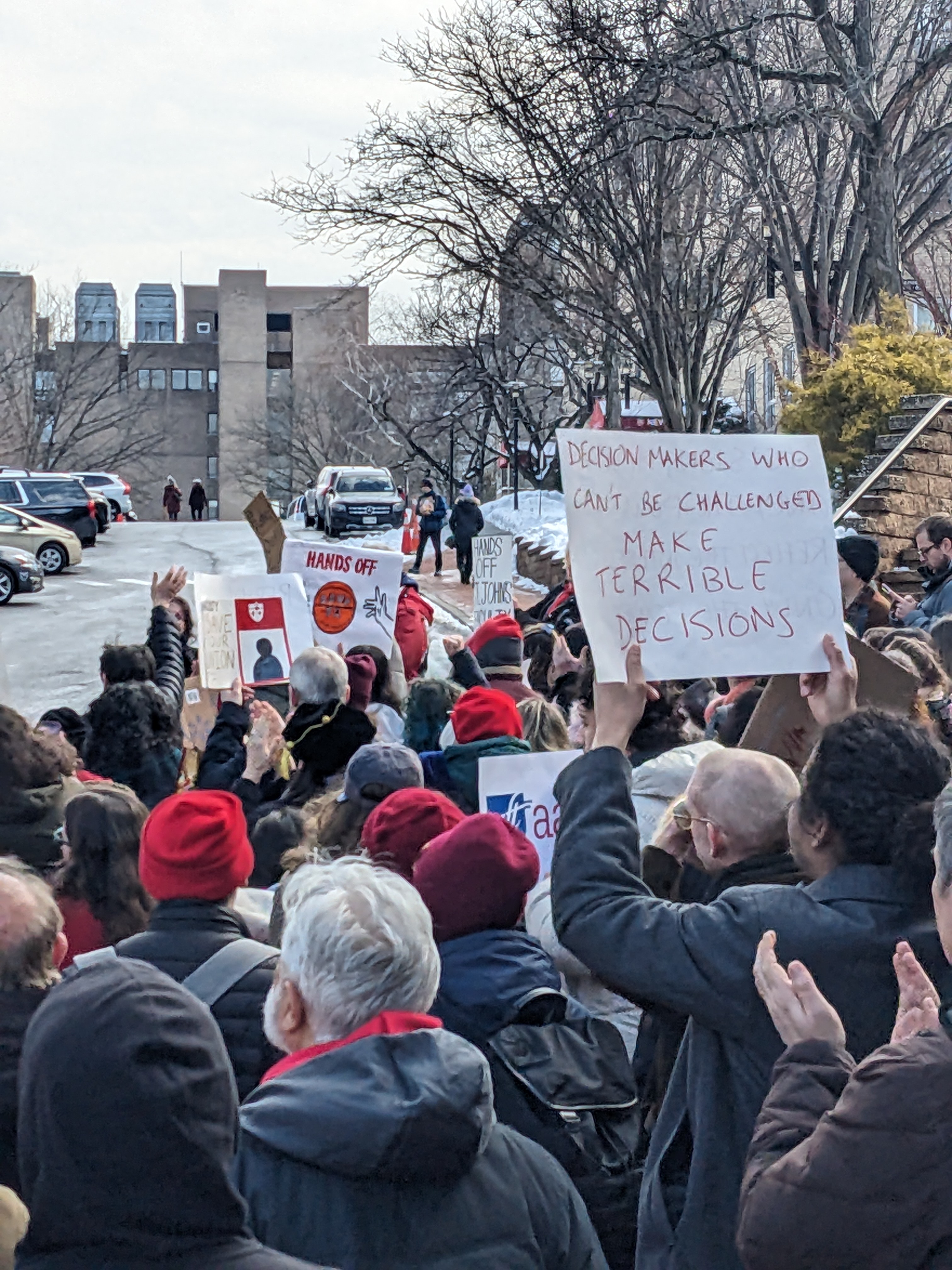 Protesters march at St. John's University after the university announced it would no longer recognize two faculty unions. Photo via SJU-AAUP.