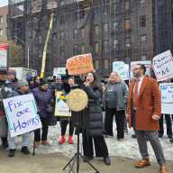 Council Member Julie Won and displaced tenants rally outside a Sunnyside building destroyed by fire.