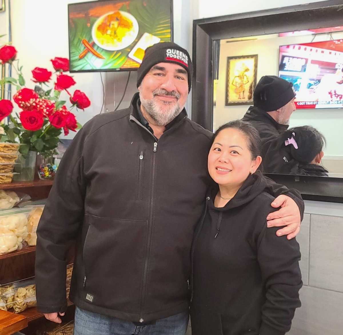 Queens Together founder Jonathan Forgash alongside Asian Taste 86 owner Rosalinda Lie. Lieis profiding food relief to victims of the Dongan Avenue fire. Photo via Queens Together.