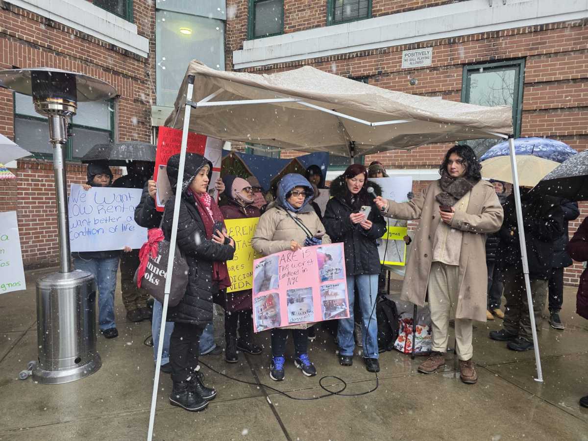 Mesa Verde tenant Mirela Bugalia speaks at Sunday's rally demanding A&E make repairs at the six-building complex. Photo by Shane O'Brien.