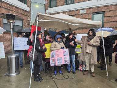 Mesa Verde tenant Mirela Bugalia speaks at Sunday's rally demanding A&E make repairs at the six-building complex. Photo by Shane O'Brien.