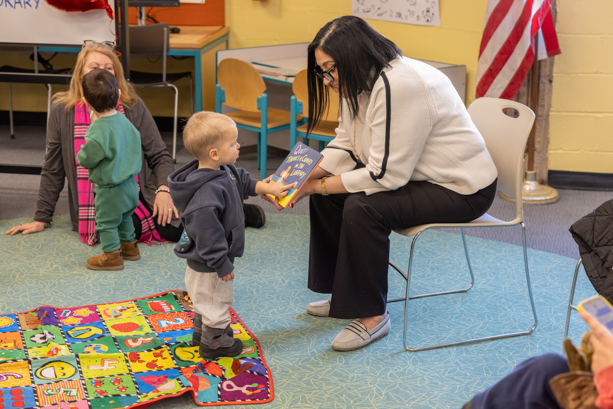 Ariola discusses a book with one of her younger constituents. 