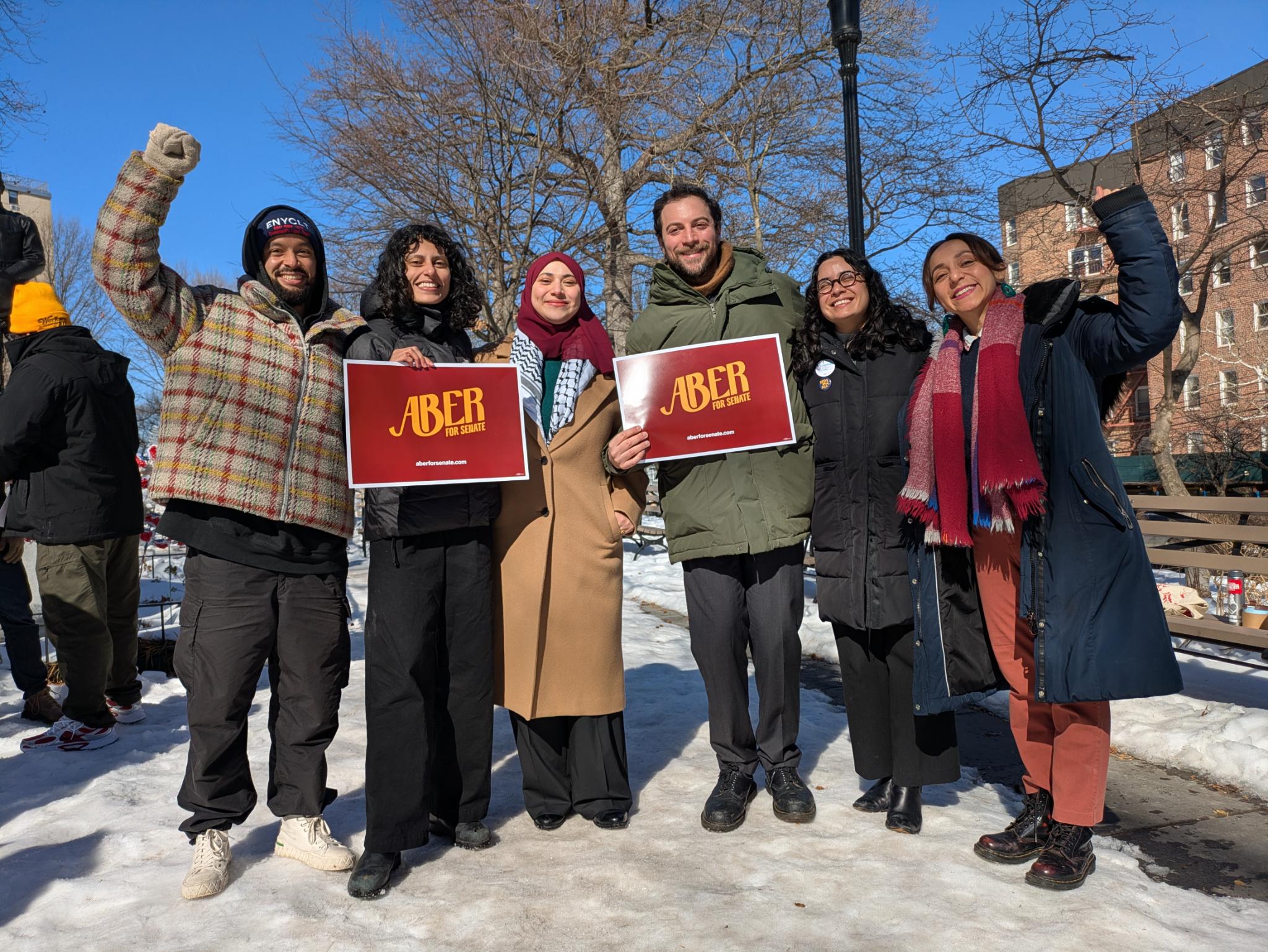 Senate District 12 candidate Aber Kawas with a number of DSA candidates and elected officials at Woodside's Doughboy Plaza last week. Photo via Aber for Senate.