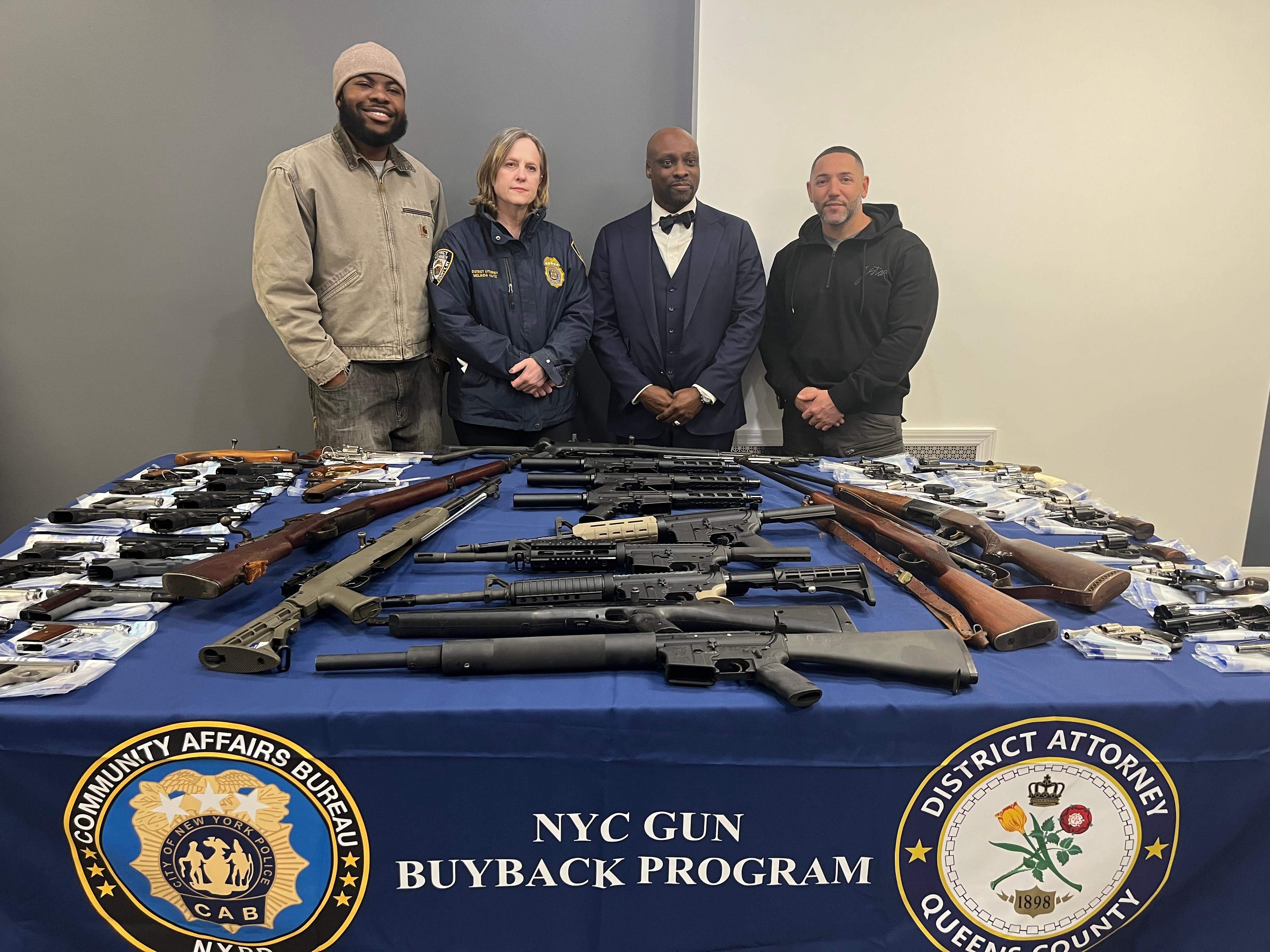 Queens District Attorney Melinda Katz shows off the 124 firearms that were surrenders at a gun buyback she hosted at Mount Olivet Baptist Church in St. Albans.