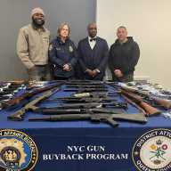 Queens District Attorney Melinda Katz shows off the 124 firearms that were surrenders at a gun buyback she hosted at Mount Olivet Baptist Church in St. Albans.