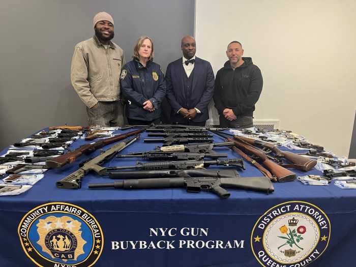 Queens District Attorney Melinda Katz shows off the 124 firearms that were surrenders at a gun buyback she hosted at Mount Olivet Baptist Church in St. Albans.