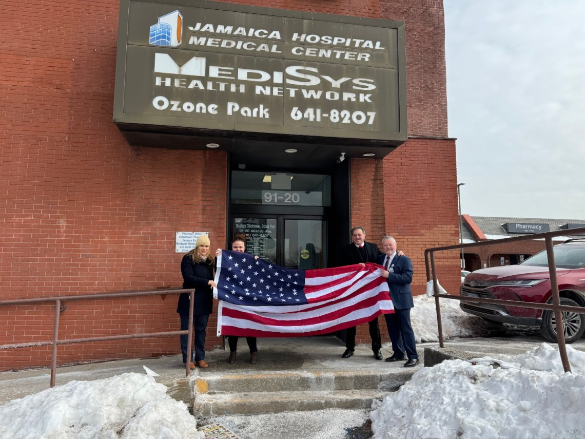 Sen. Addabbo replaces worn down American flag at Jamaica Hospital building to celebrate USO anniversary
