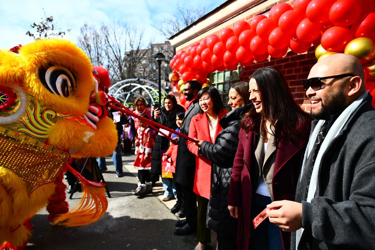 Elected officials feed ceremonial lions at a Lunar New Year event hosted by Council Member Shekar Krishnan and Assembly Members Catalina Cruz and Steven Raga. Photo via Ramy Mahmoud.