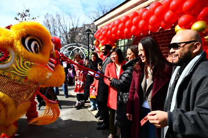 Elected officials feed ceremonial lions at a Lunar New Year event hosted by Council Member Shekar Krishnan and Assembly Members Catalina Cruz and Steven Raga. Photo via Ramy Mahmoud.