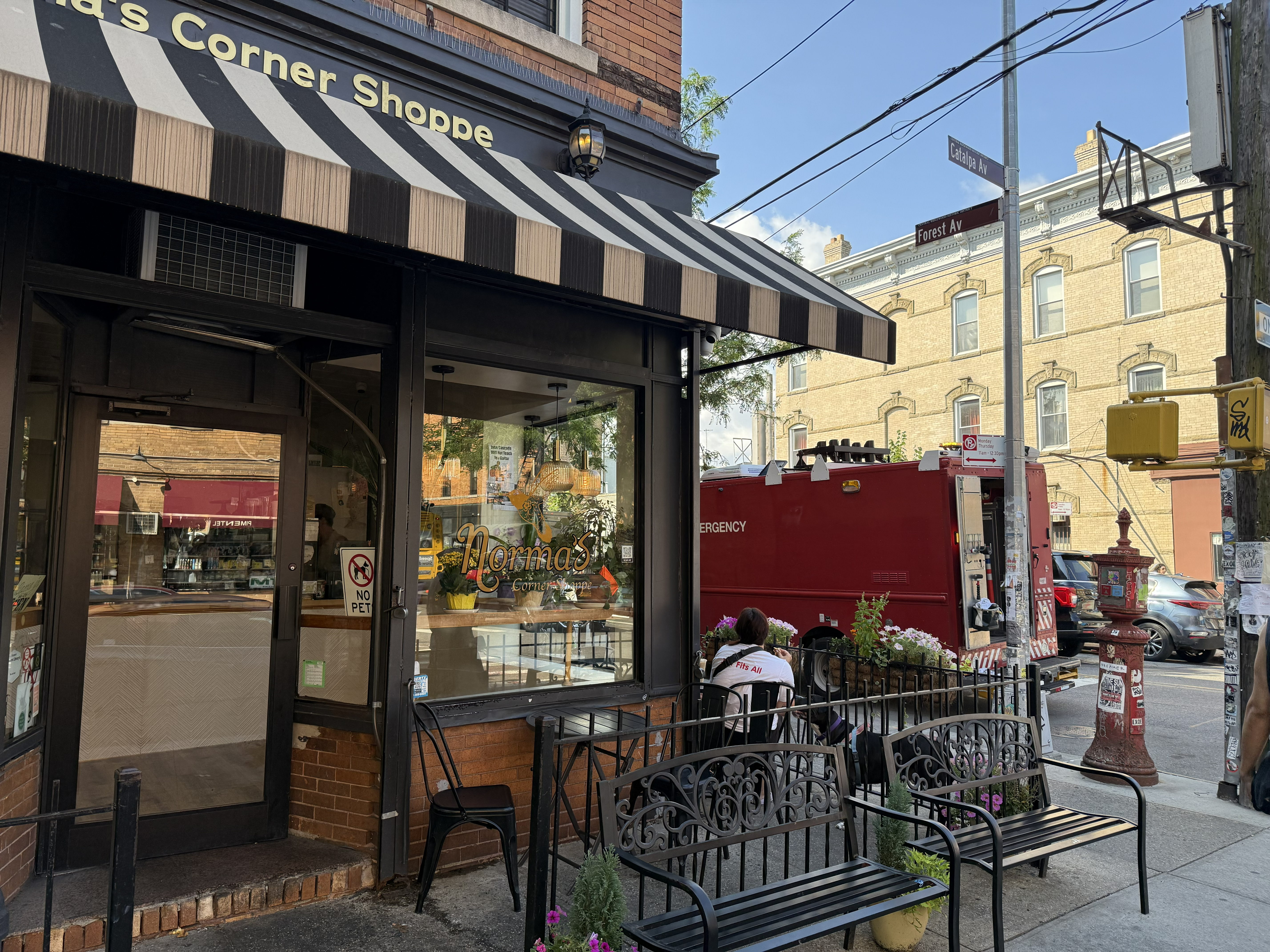 A Con Edison emergency service truck parked out front of Norma's Corner Shoppe.